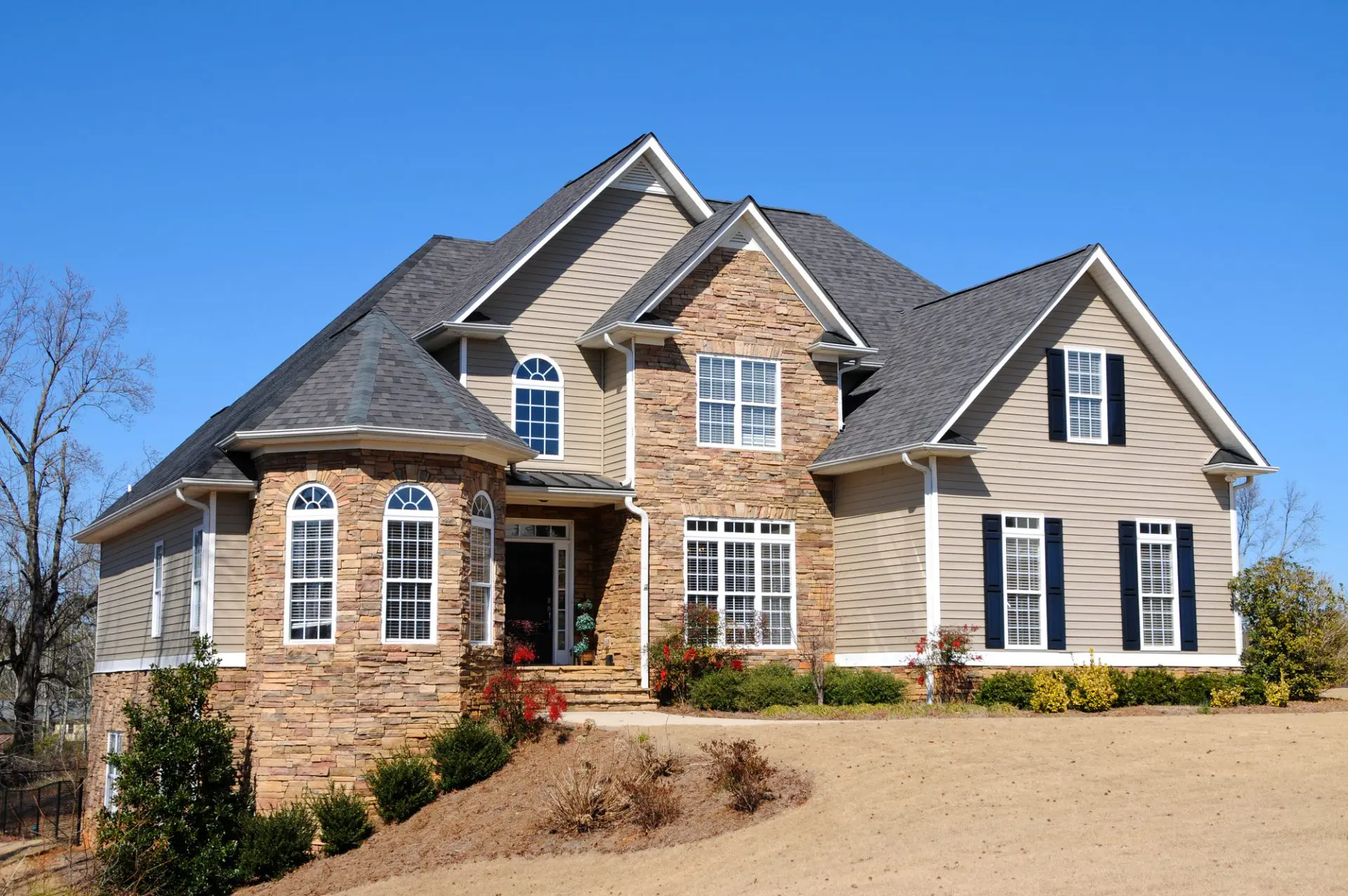Elegant two-story house with stone and siding exterior.
